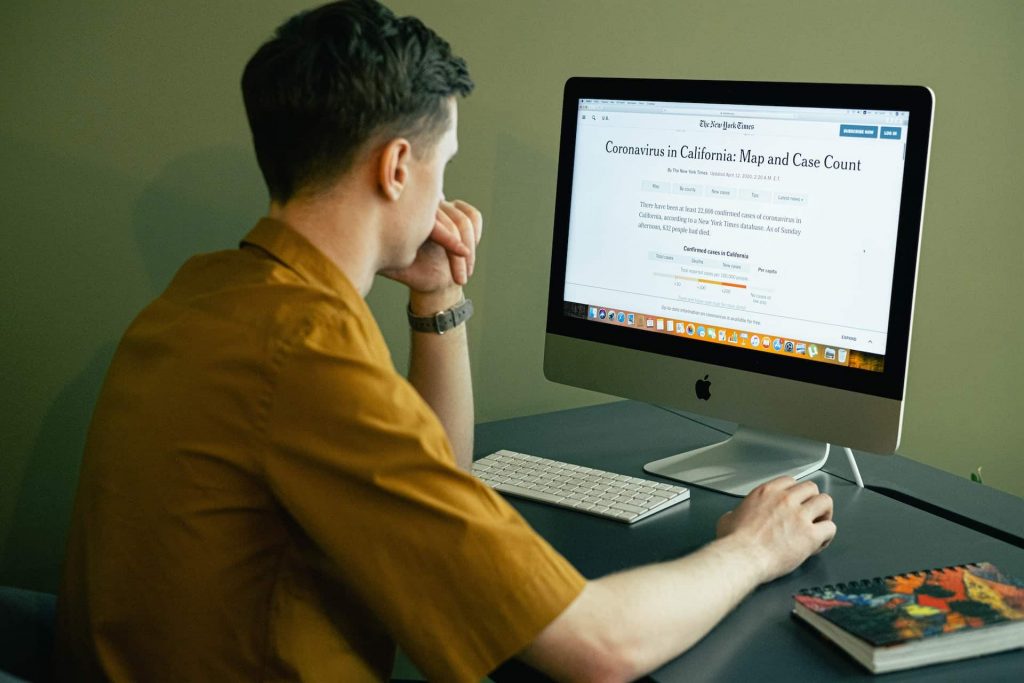 a man reading a newspaper online