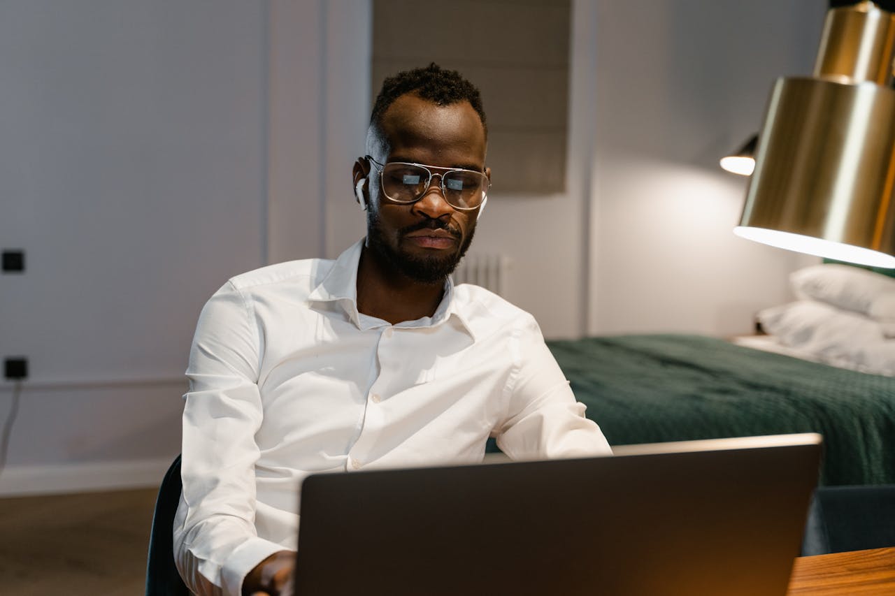 Man in white shirt sitting at desk